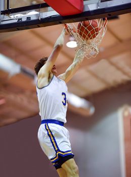 Young athletes making great basketball plays during a game. Slam Dunks and layups