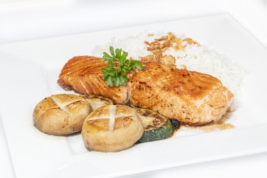 Stir pan fried salmon served with mushroom, zucchini and rice