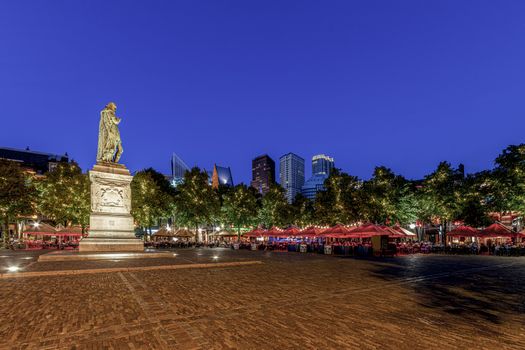 Central place of The Hague city called 'Het Plein' where locals and tourists enjoy the late summer warm diner with music