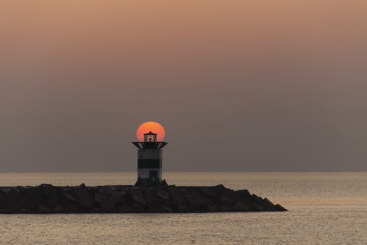 Sunset on the lighthouse of Scheveningen harbor at the summer hottest day ever