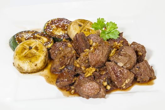 Stir fried beef served with mushroom, zucchini and soy sauce