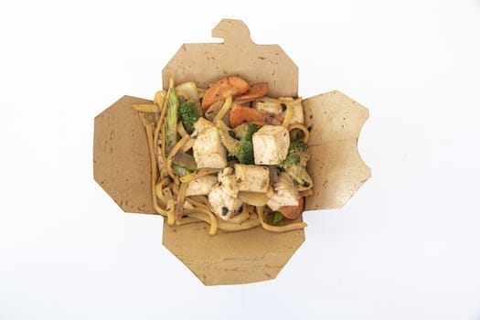 Box of stir fried chicken and tofu noodle served in a paper box for take away