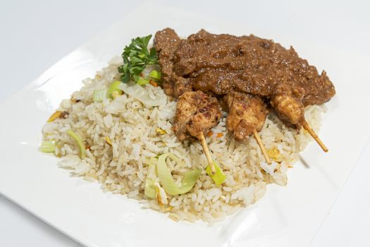 Chicken skewers served with a tasty peanut sauce and fried rice