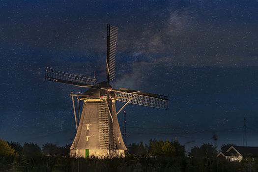 Majestic windmill against the milky way at the bleu hour sunset in Alblasserdam city, Netherlands