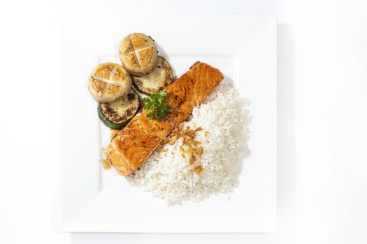 Stir pan fried salmon served with mushroom, zucchini and rice