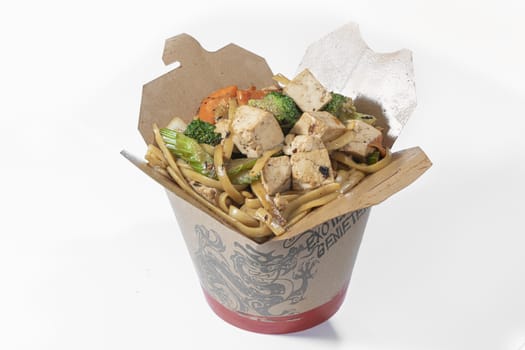 Box of stir fried chicken and tofu noodle served in a paper box for take away