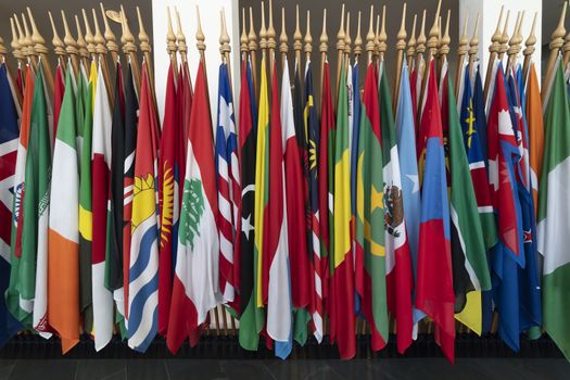 Display of flags of all countries packed t each other within a international organization hall way in The Hague, Netherlands