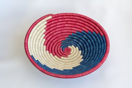 Red and blue wicker basket to arrange fruits and vegetables on a table.