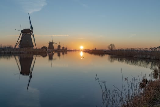 Twight light sunrise on the Unesco heritage windmill silhouette at the middle of the canal, Alblasserdam, Netherlands