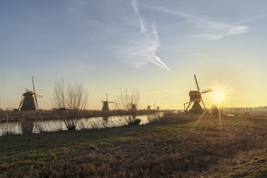 Twight light sunrise on the Unesco heritage windmill silhouette at the middle of the canal, Alblasserdam, Netherlands