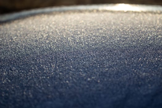 Frost on the car. Details of the car. Getting the sun and frost. Early spring Sunrise Morning