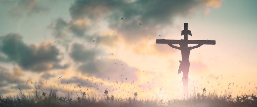 Silhouette jesus christ crucifix on cross on calvary sunset background concept for good friday he is risen in easter day, good friday jesus death on crucifix, world christian and holy spirit religious.