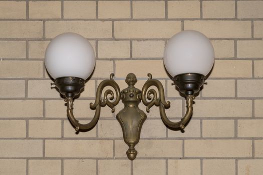 Antique lamp, lantern against a bricks wall