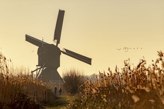 Twight light sunrise on the Unesco heritage windmill silhouette at the middle of the canal, Alblasserdam, Netherlands