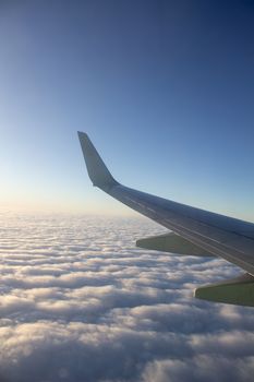 Airplane wing in the sky. View from a great height