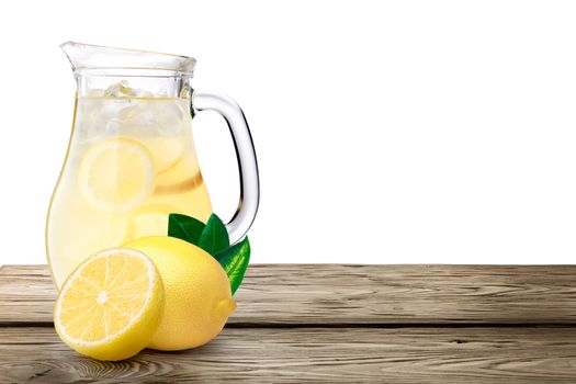 Lemonade pitcher with lemons on wooden table. Clipping paths, infinite depth of field