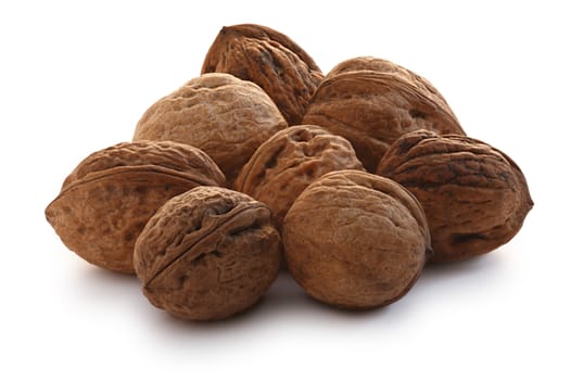 Heap of shelled whole walnuts (edible seeds of tree of Juglans regia). Clipping paths for both nuts and shadow, infinite depth of field