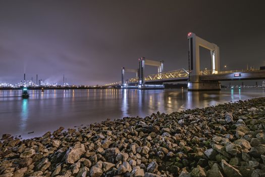 ROTTERDAM, 21 March 2019 - View of the Dutch Betlek bridge over the river and against the Rotterdam chemical industrial complex.