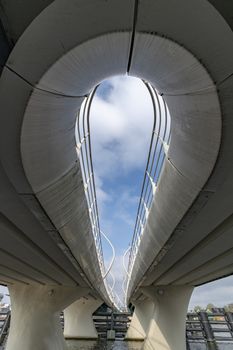 Curvy bridge structure viewed from below at the Amstel river level