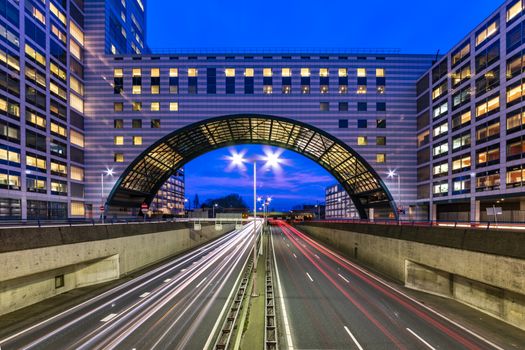 Buildings over the end of A12 highway entering inside The Hague city during the blue hours, Netherlands