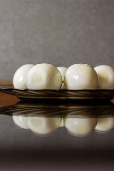 Peeled eggs on a black plate. Hard-boiled eggs. Cooking