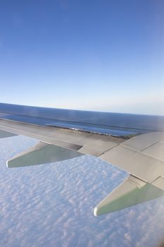 Airplane wing in the sky. View from a great height
