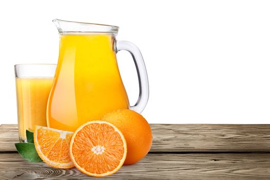 Jug or pitcher of orange juice with oranges on wooden table. Clipping paths, infinite depth of field