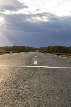 Large paved road in the middle of the field. Greater depth of field