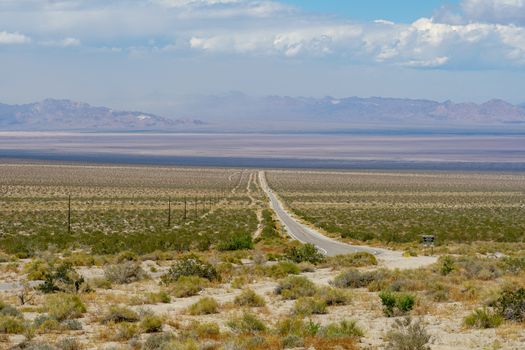 Endless desert road. Long straight road in desert. Adventure travel in a desert. California. USA