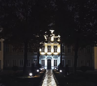 Exterior facade of classic building in the European city at night, architecture and design detail