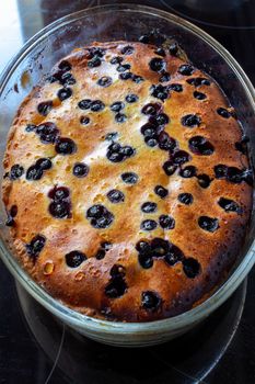 Cottage cheese casserole baked with blueberry. Curd casserole with fresh berries on kitchen table. Top view