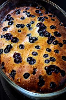Cottage cheese casserole baked with blueberry. Curd casserole with fresh berries on kitchen table. Top view