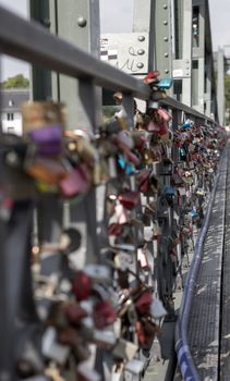 Padlocks on a bridge in Frankfurt am main, Germany. The ritual of attaching padlocks as a symbol of love to a bridge has been common in Europe since the 2000s.