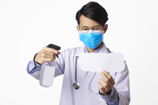 Asia doctor using spray alcohol cleaning mockup paper for protect anti virus bacteria.