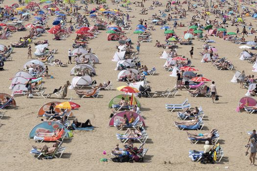 SCHEVENINGEN, 2 June 2019 - Aerial view of the beach of The Hague with crowded people enjoying take sun bath during the hot and sunny day before the summer.