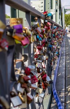 Padlocks on a bridge in Frankfurt am main, Germany. The ritual of attaching padlocks as a symbol of love to a bridge has been common in Europe since the 2000s.