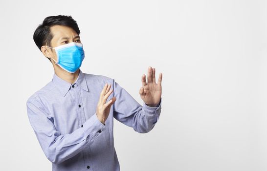 Asia man panic disorder wearing surgical mask covering mouth and nose. epidemic corona virus protection.