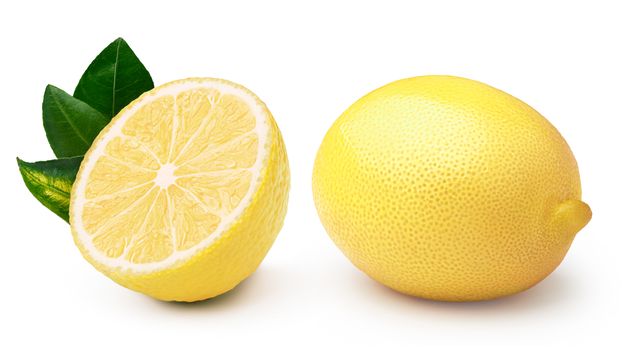 Whole and halved lemon with leaves, separated. Clipping paths, infinite depth of field