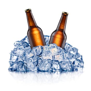 Two brown beer bottles, cooling down in a rough crushed ice. Clipping paths