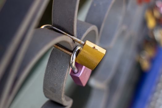 Padlocks on a bridge in Frankfurt am main, Germany. The ritual of attaching padlocks as a symbol of love to a bridge has been common in Europe since the 2000s.