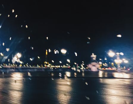 Abstract night city scene in Paris, France, motion blurred lights in the dark