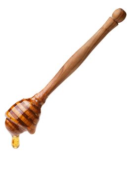 Wooden honey dipper with dripping honey. Large depth of field,clipping path