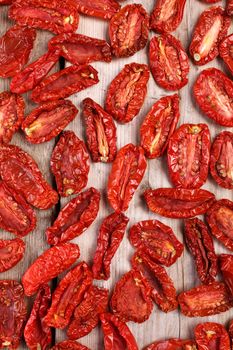 Sun dried tomatoes on wooden backdrop