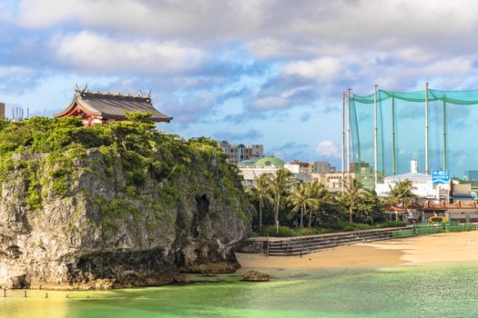 Sunrise landscape of the Shinto Shrine Naminoue at the top of a cliff overlooking the beach and ocean of Naha in Okinawa Prefecture, Japan.