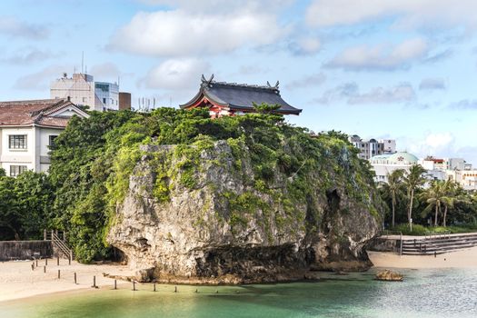 Summer landscape of the Shinto Shrine Naminoue at the top of a cliff overlooking the beach and ocean of Naha in Okinawa Prefecture, Japan.