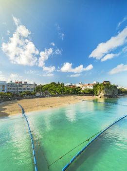 Sunrise landscape of the Shinto Shrine Naminoue at the top of a cliff overlooking the beach and ocean of Naha in Okinawa Prefecture, Japan.