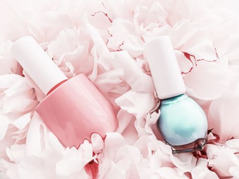 Nail polish bottles on floral background, french manicure and cosmetic branding design