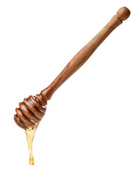 Wooden honey dipper with dripping honey. Large depth of field,clipping path