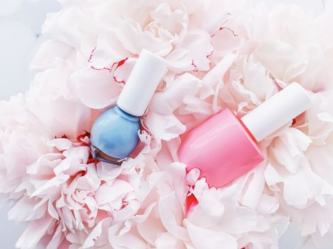 Nail polish bottles on floral background, french manicure and cosmetic branding design