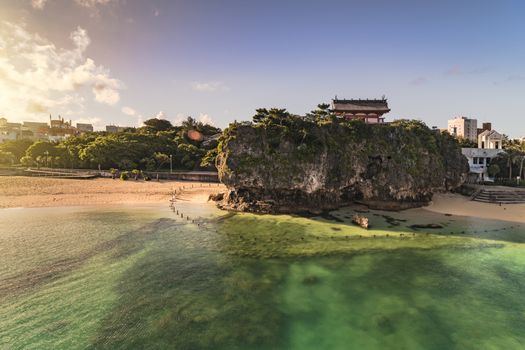 Sunrise landscape of the Shinto Shrine Naminoue at the top of a cliff overlooking the beach and ocean of Naha in Okinawa Prefecture, Japan.